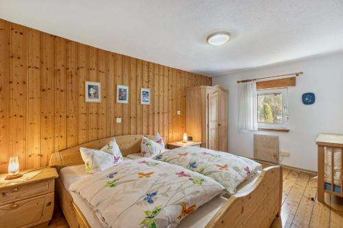 a bedroom with a bed and a wooden wall at Feriewohnung Hirtenhaus in Attendorn