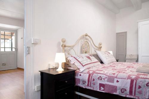 a bedroom with a bed and a lamp on a table at La Vecchia Torre in Porto Valtravaglia