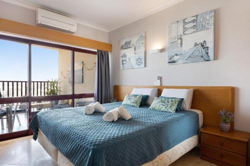 a bedroom with a bed with towels on it at Sunny Escape in Portimão