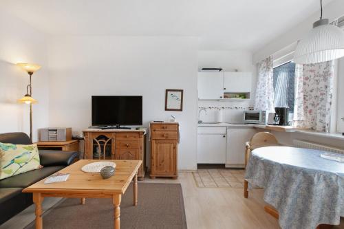 a living room with a couch and a table at Haus Halligblick in Dagebüll