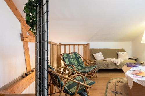 a living room with two chairs and a couch at Gite La Sabaudia in Gérardmer