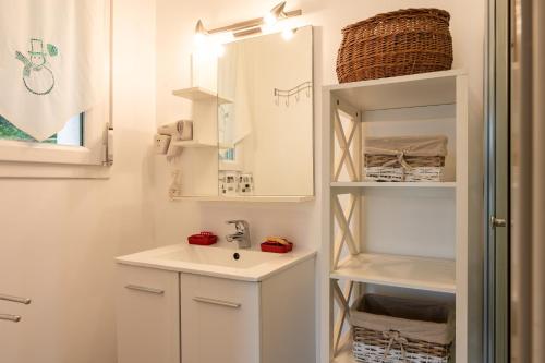 a bathroom with a sink and a mirror at Gite La Sabaudia in Gérardmer