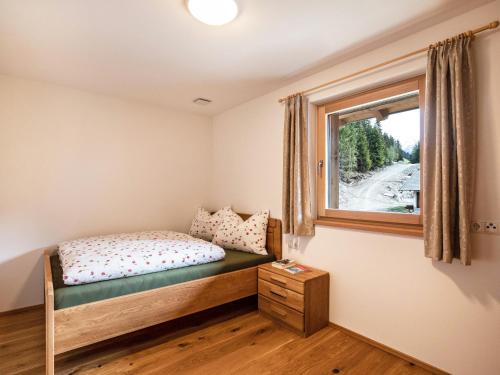 a bedroom with a bed and a window at Pfattenspitz Maurerhof in Valdurna