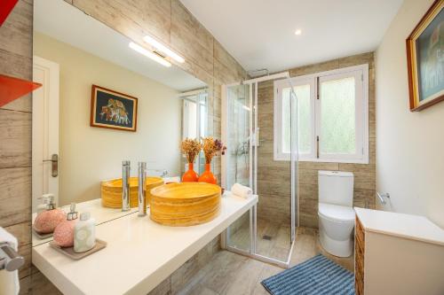a bathroom with a sink and a toilet and a shower at Finca Es Pi in Llucmajor