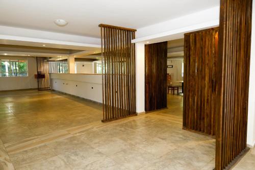 a large room with wooden partition walls and a table at Fairways Hotel in Narok
