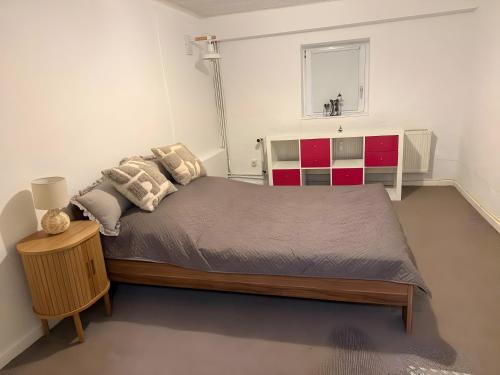 a bedroom with a large bed and red cabinets at Ferienwohnung Silbergarten in Clausthal-Zellerfeld