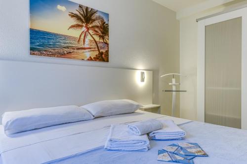 a bedroom with a bed with two towels on it at Residence Margherita in Ugento