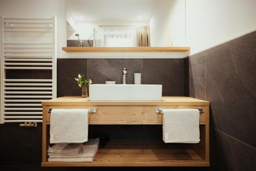 a bathroom with a sink and a counter with towels at Chalet La Flüta Viola in La Valle
