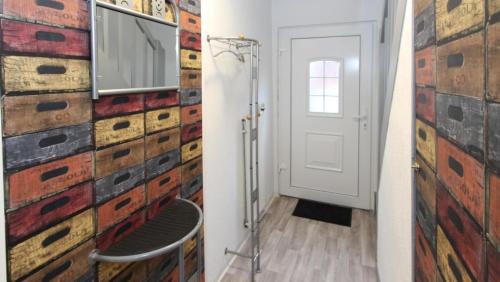 a hallway with a brick wall and a white door at Ferienhaus Olenbrook in Cuxhaven