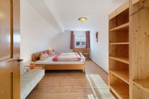 a bedroom with a bed and a book shelf at Hofgut Dürrenbühl in Grafenhausen