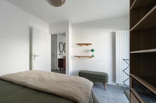 a bedroom with a bed and a chair at Cocon Terrasse près du Port - A102 in Pornic