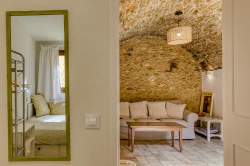 a living room with a couch and a mirror at Apartamento en el centro in Begur