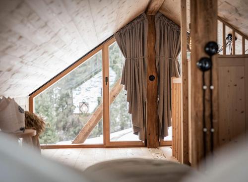 a room with a large window in a house at Burgfrieder Mühle in Rasun di Sopra