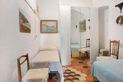 a room with two beds and a table and chairs at Casa Paola in Levanto