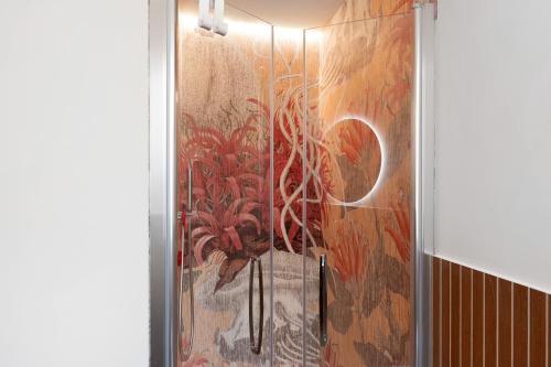 a shower stall with a painting on the wall at Saint Claude in Marina di Andora