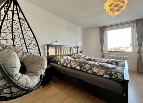 a bedroom with a bed and a swing at Ferienwohnung Ate´s kleine Welt in Brilon