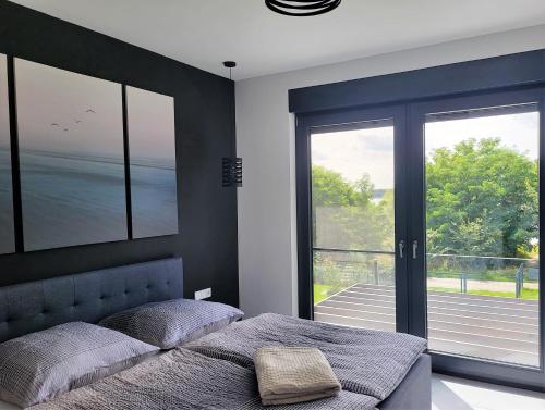 a bedroom with two beds and a large window at Ferienhaus Schlossterrassen 4a in Pouch