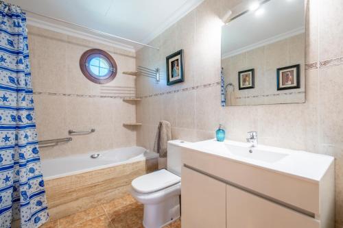 a bathroom with a sink and a toilet and a tub at Que Bo in Alcudia