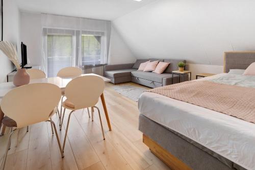 a bedroom with a bed and a table and chairs at Isabell in Schönwald