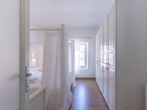 a white bathroom with a sink and a shower curtain at Delicious House Michelangelo in Cavaion Veronese