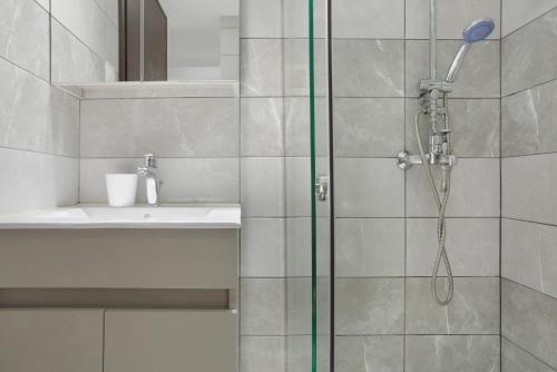 a bathroom with a shower and a sink at Villa Dionysia Apartment A2 in Alikanas