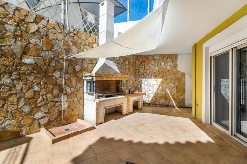 a stone wall with a stone stove in a room at Evagelia Luxury Apartment 2 in Nikiana