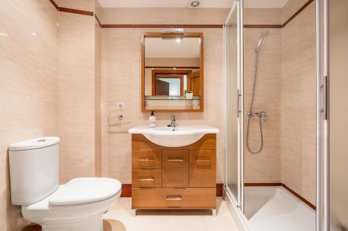 a bathroom with a toilet and a sink and a shower at Casa Ramirez in Güéjar-Sierra