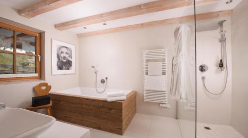 a bathroom with a bath tub and a shower at Chalet Sonnberg Bramberg in Bramberg am Wildkogel