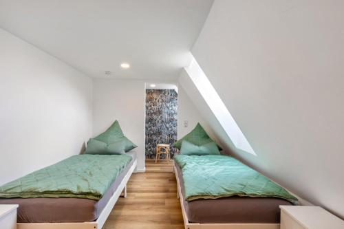 two beds in a room with a staircase at Werner-Senger-Haus Limburg in Limburg an der Lahn