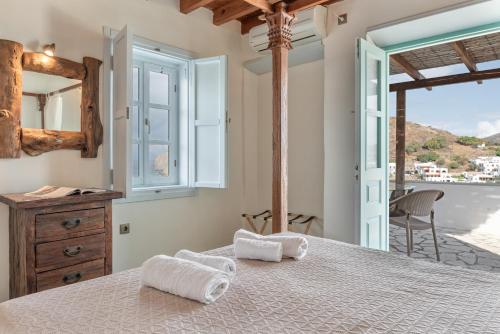 a bedroom with a bed with towels on it at Santanna Suites in Patmos