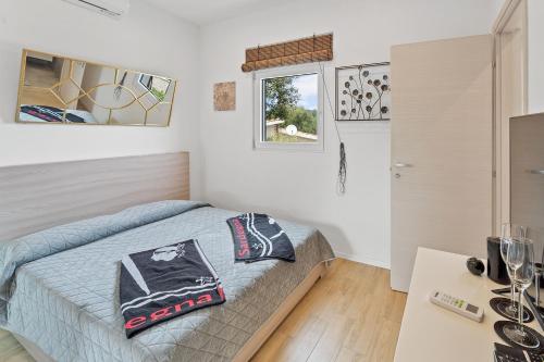a bedroom with a bed and a table at Villa Matteo Suite in Porto Columbu - Perdʼe Sali
