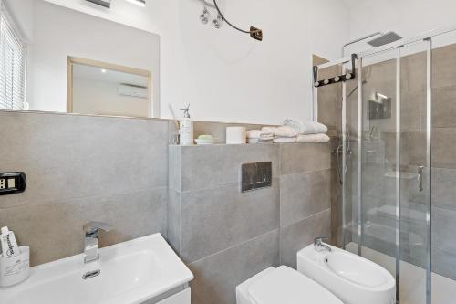 a bathroom with a shower and a toilet and a sink at Villa Matteo Suite in Porto Columbu - Perdʼe Sali