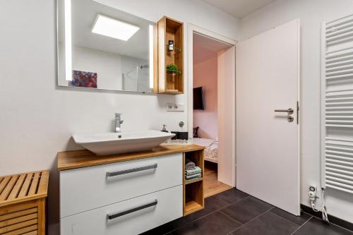 a bathroom with a sink and a mirror at Haus Frigger in Olsberg