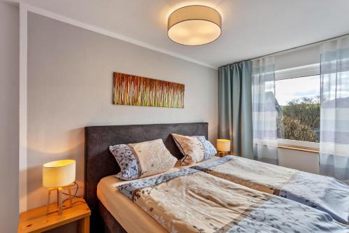 a bedroom with a bed and a window at Haus Frigger in Olsberg