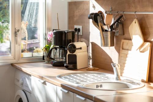a kitchen counter with a sink and a coffee maker at Superbe Duplex en centre ville in Douarnenez
