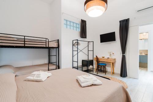 a bedroom with two bunk beds and a desk at Casa Margherita in Matino