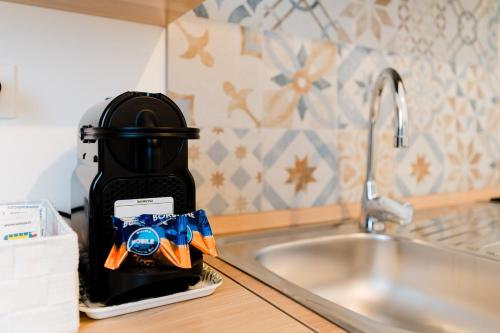 a coffee maker sitting on a counter next to a sink at Casa Margherita in Matino