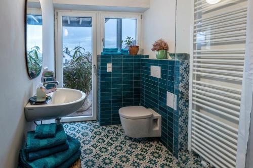 a bathroom with a sink and a toilet and a tub at Seeapartment Höri in Gaienhofen