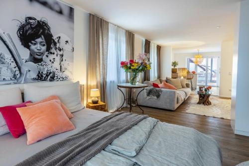 a bedroom with a bed and a living room at Seeapartment Höri in Gaienhofen