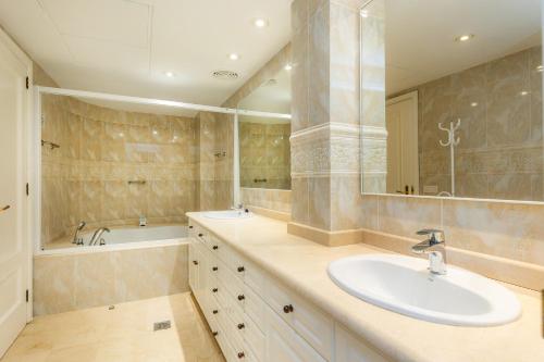 a bathroom with a sink and a tub at Olympo in Port de Pollensa