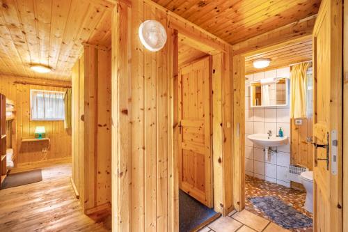 a wooden bathroom with a sink and a toilet at Bungalow 12 - Finnhütte in Niesky
