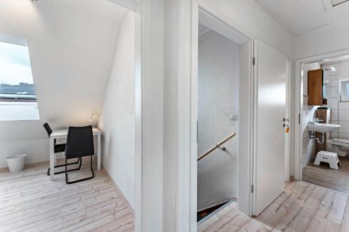 a white room with a table and a chair at Haus Kasberger in Ascheberg