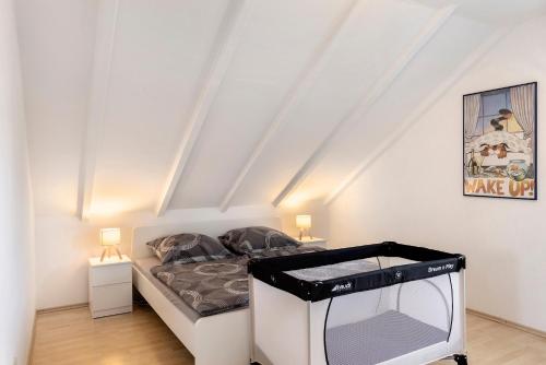 a small bedroom with a bed and a tv at Ferienwohnung Schliestädt in Wellerode
