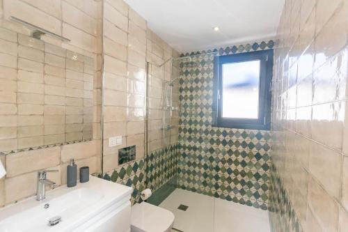 a bathroom with a shower and a sink and a toilet at Luxury apartment in Cómpeta in Cómpeta