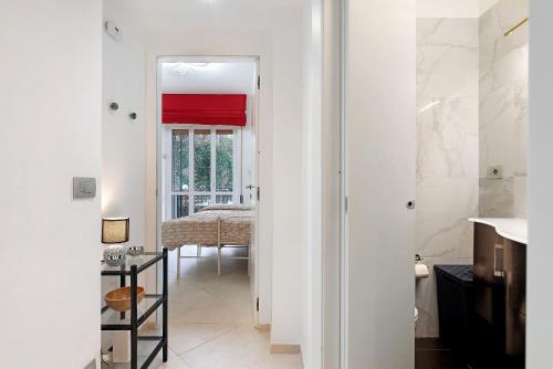 a bathroom with a sink and a room with a table at Margherita - Fronte Mare in Rapallo