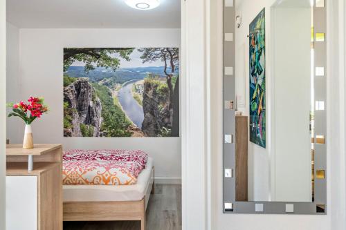a bedroom with a view of a river and mountains at Ferienwohnung Marks - Hohnstein in Rathewalde