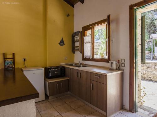 a small kitchen with a sink and a window at Adamantia Studio S1 in Gaios