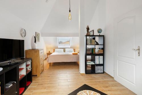a bedroom with a bed and a book shelf at Ferienwohnung in Potsdam in Potsdam
