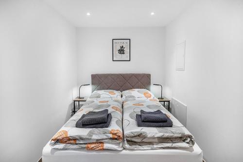 a bed with two pillows on it in a room at Tor zum Hochwald in Thomm