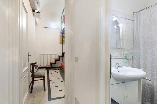 a white bathroom with a sink and a toilet at Casa Meloria in Finale Ligure